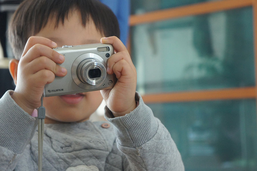 Boy learning play camera