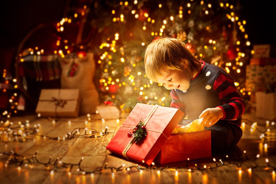 Little boy opening gift