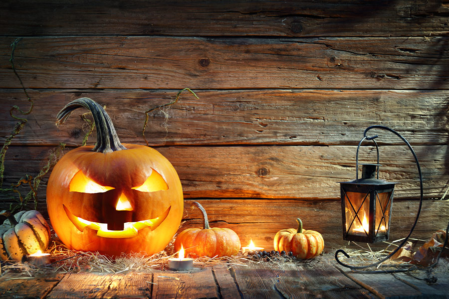 Jack lantern on wooden table with lantern