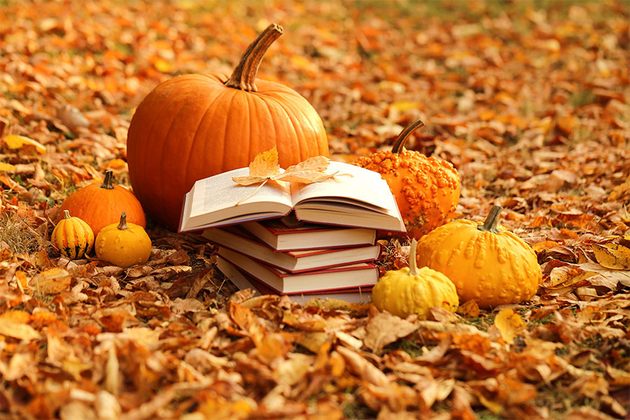 Autumn books and orange pumpkin