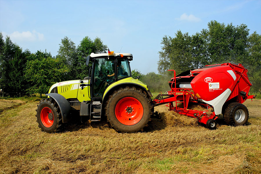 Harvesting tractor on field