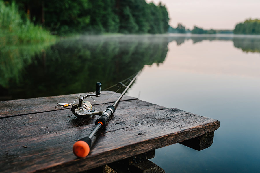 Fishing rod spider reel on the bank