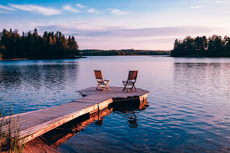Two wooden chairs on wooden pier