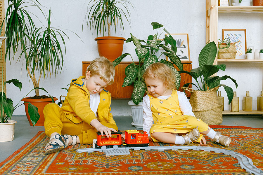 Adorable kids playing toy train