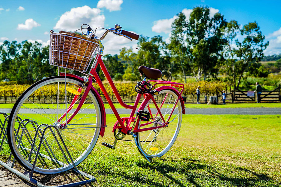 Red cruiser parked on metal bike stand