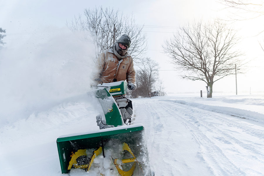 Man with snow blower