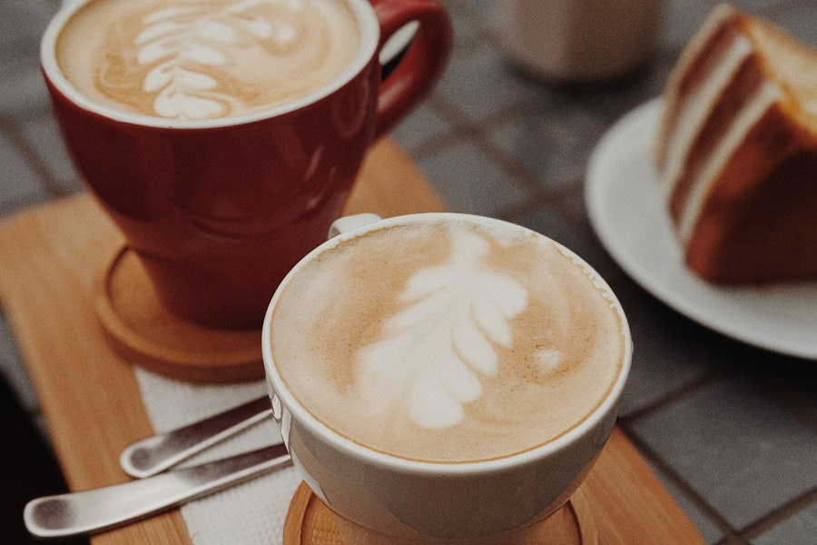 Cups of coffee on top of brown tray