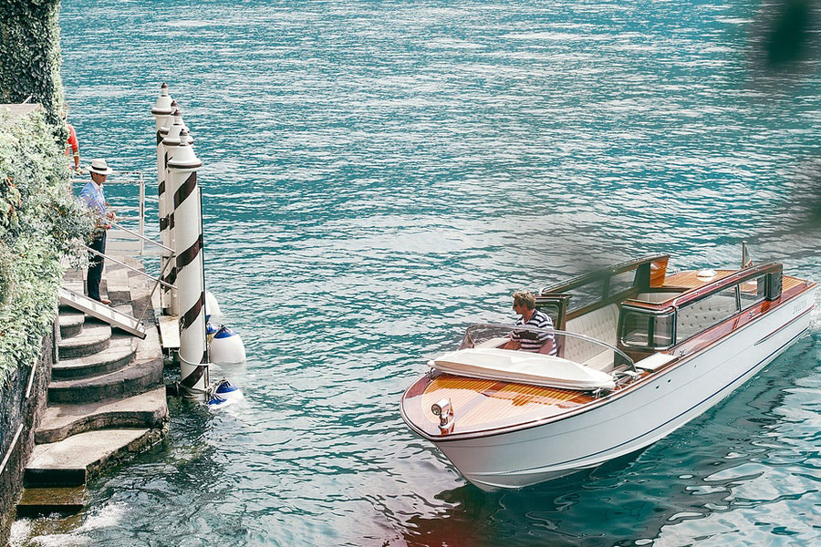 Motor boats on rippled sea against ridge and anonymous tourist