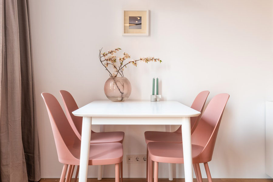 Dining able and pink chairs in light dining room