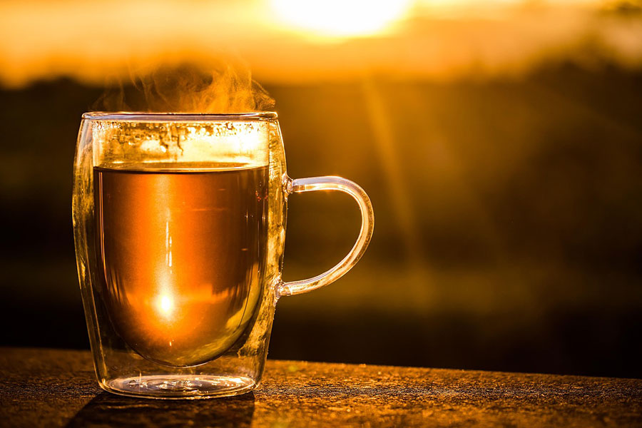 Steaming cup of tea in a double walled glass