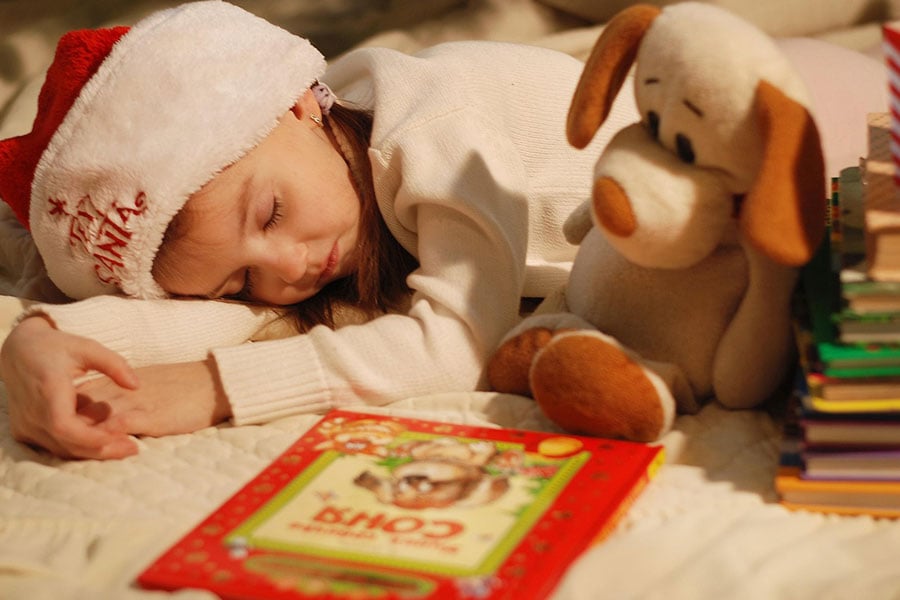 Girl in a Christmas hat sleeping
