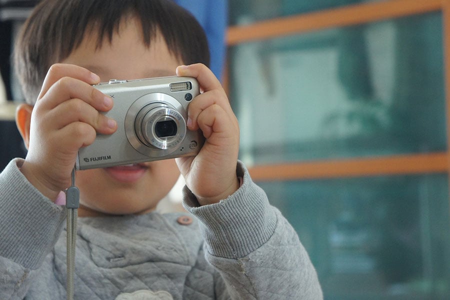 Boy learning play camera