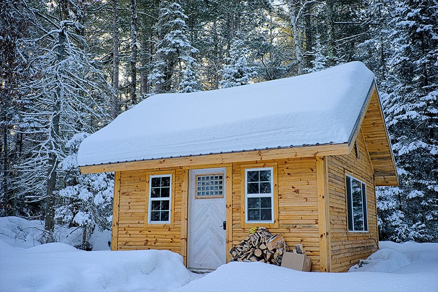 Snow covered wooden house