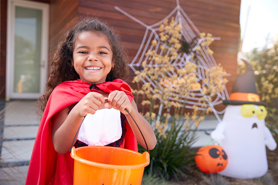 Girl collecting candy for trick or treat