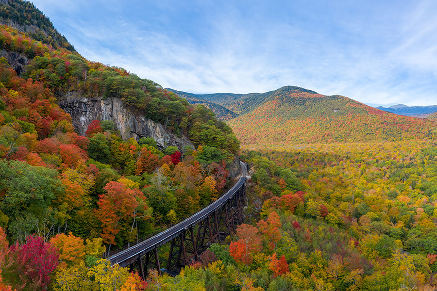 New Hampshire with train track trestle curving around mountainside