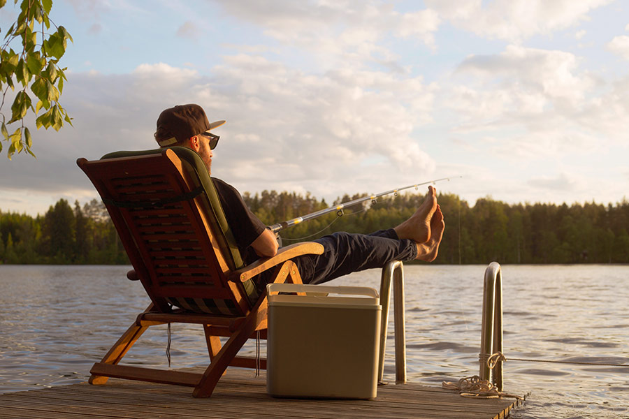 Man fishing from wooden pier