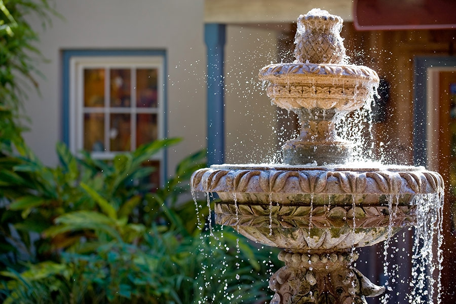 Two tiered garden fountain flowing with water