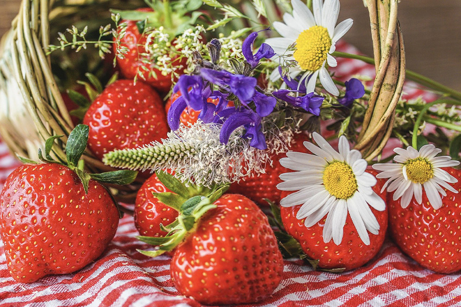 Ripe strawberries with wild flowers