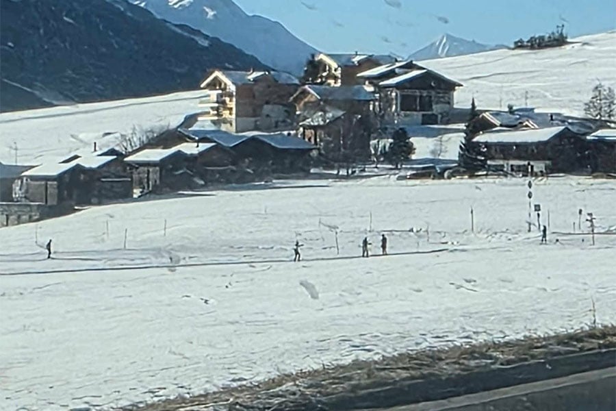 Snow covered mountain landscape with several chalet style building