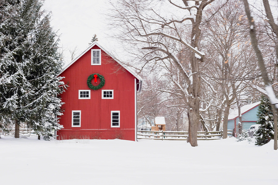 Red barn with Christmas wreath snowy midwestern day