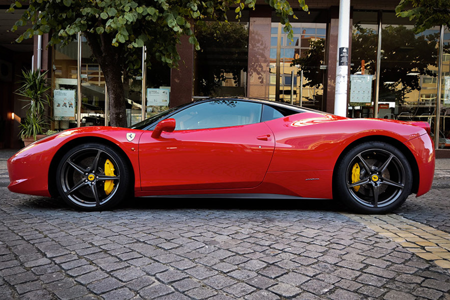 Red ferrari parked on the street