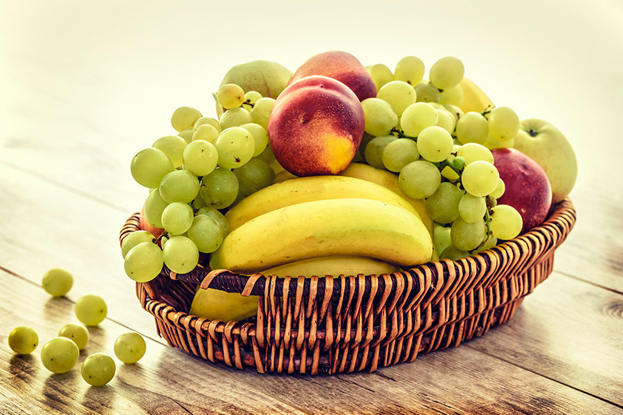 Several fruits in brown wicker basket