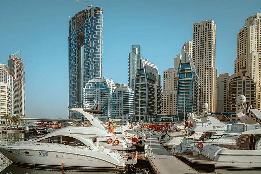 White yacht on dock near building Dubai