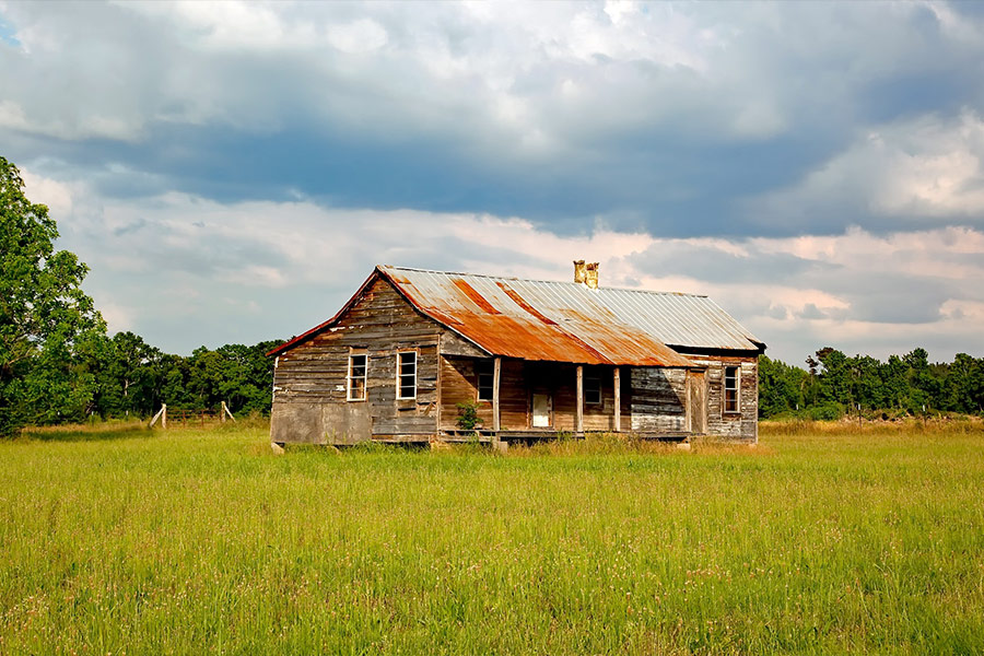 Abandoned house middle green open field