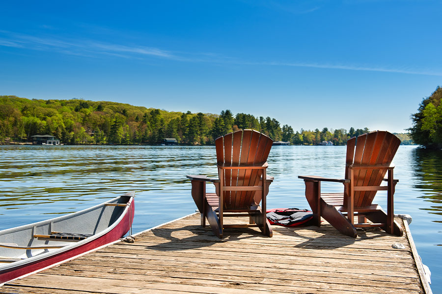 Muskoka chairs on a wooden dock