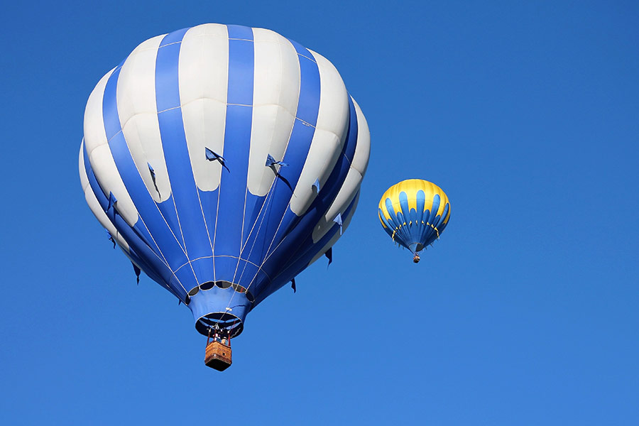 Two blue and yellow hot air balloon