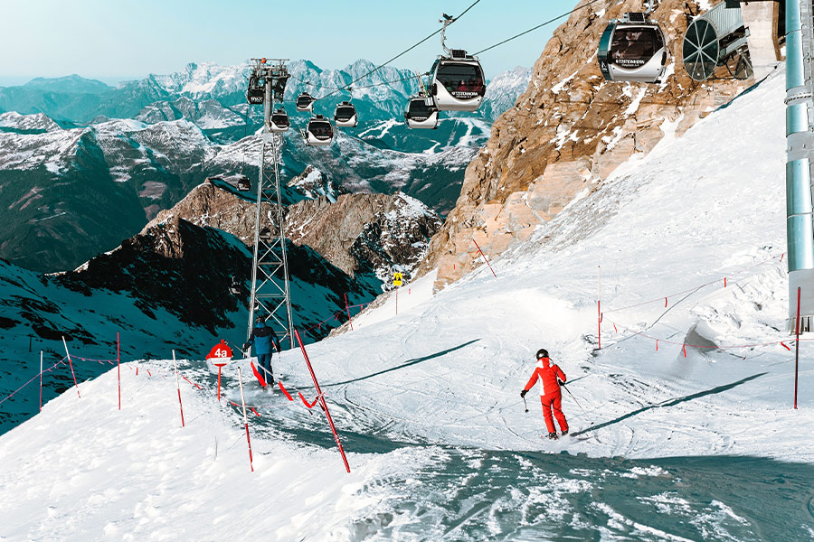 high angle people skiing snow capped mountain