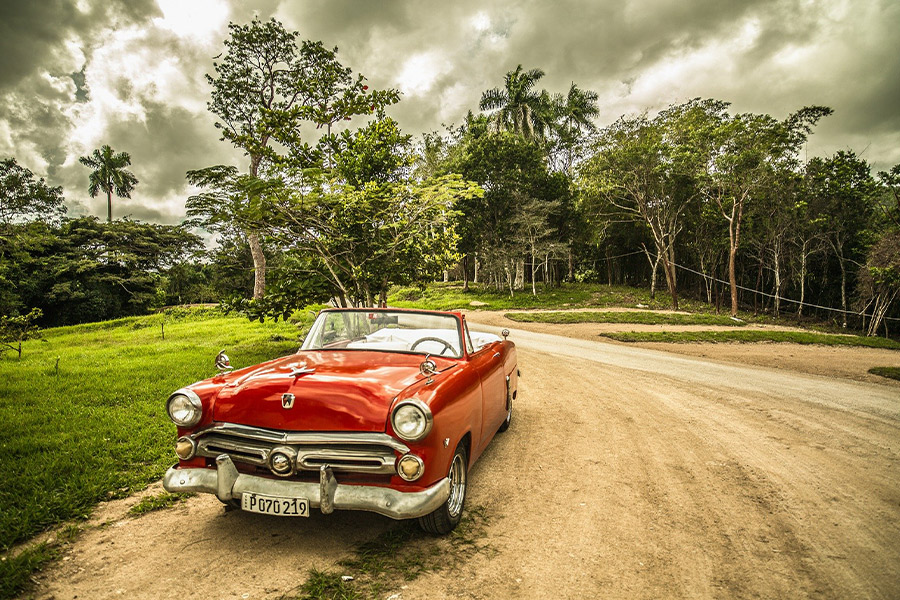 Old red car old timer travel Cuba forest