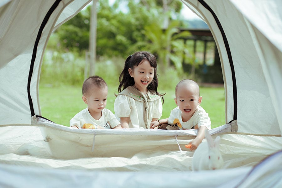Young children playing in the tent