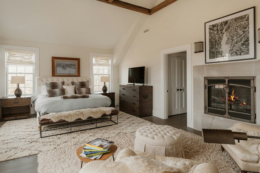 Spacious bedroom with a fireplace and large bed