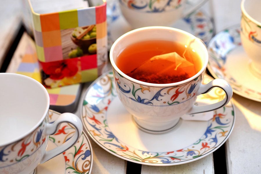 Esta taza y platillo de porcelana con té caliente