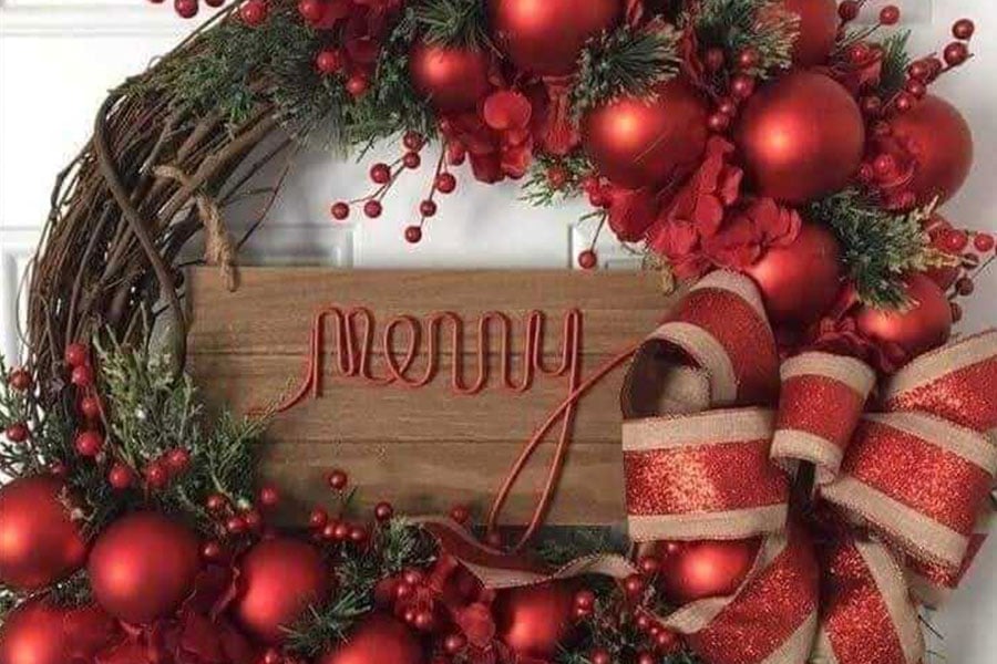 Christmas wreath made of branches red berries bow and ornaments