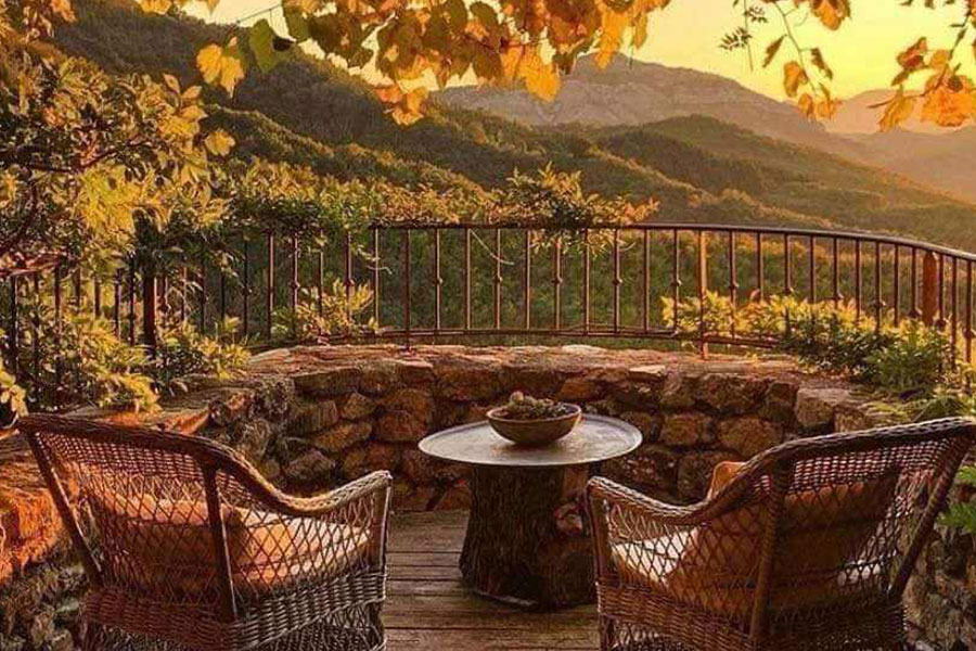 A very cozy rustic  terrace with golden yellow orange tree leaves
