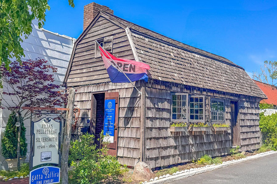 Log cabin building open flag