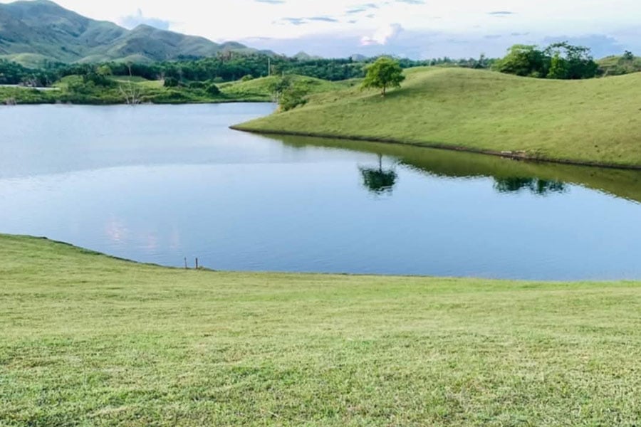 Calm picturesque landscape of lake green hills