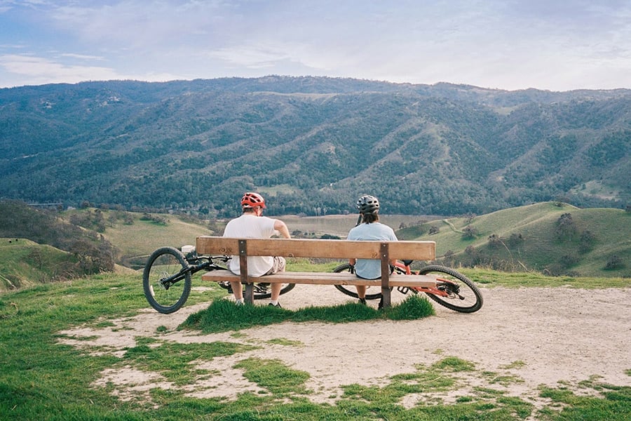 Two cyclists enjoy a scenic overlook