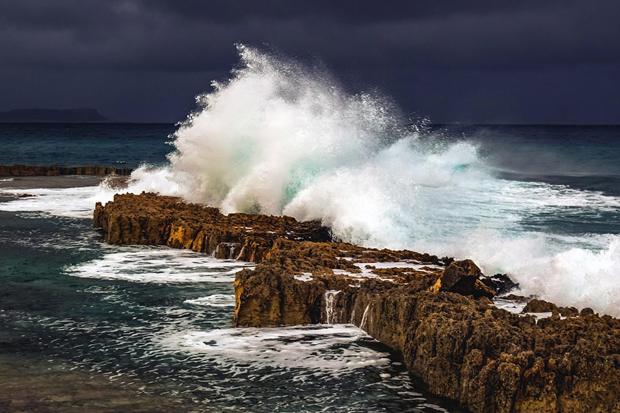 Coast sea waves with the dark cloud